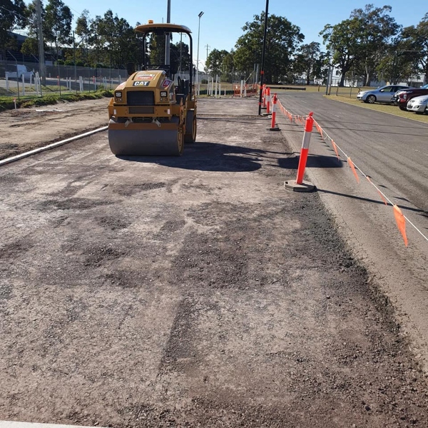 Driveway and carpark preparation in Western Sydney with roller compactor levelling and compacting the roadbase surface by West Sydney Landscapes