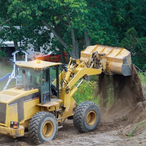 Earthmoving, site preparation, excavation and land clearing in Western Sydney with loader moving soil on a residential property by West Sydney Landscapes.