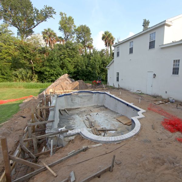 Pool removal and excavation in Western Sydney with empty concrete pool under demolition and site preparation by West Sydney Landscapes.